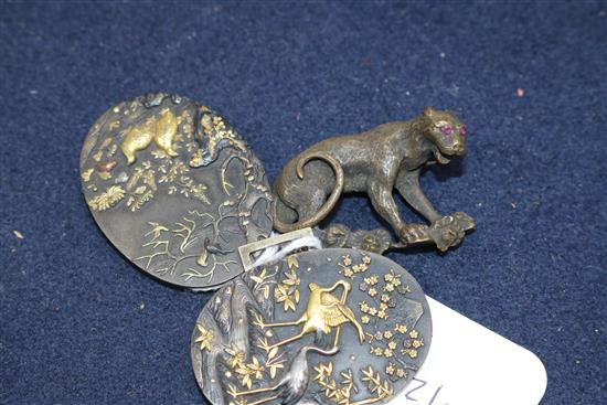 A Japanese shakudo work belt buckle and a bronze big cat brooch